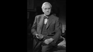 Retrato de Alexander Fleming segurando uma placa de cultura, representando a descoberta da penicilina e seu impacto na medicina moderna